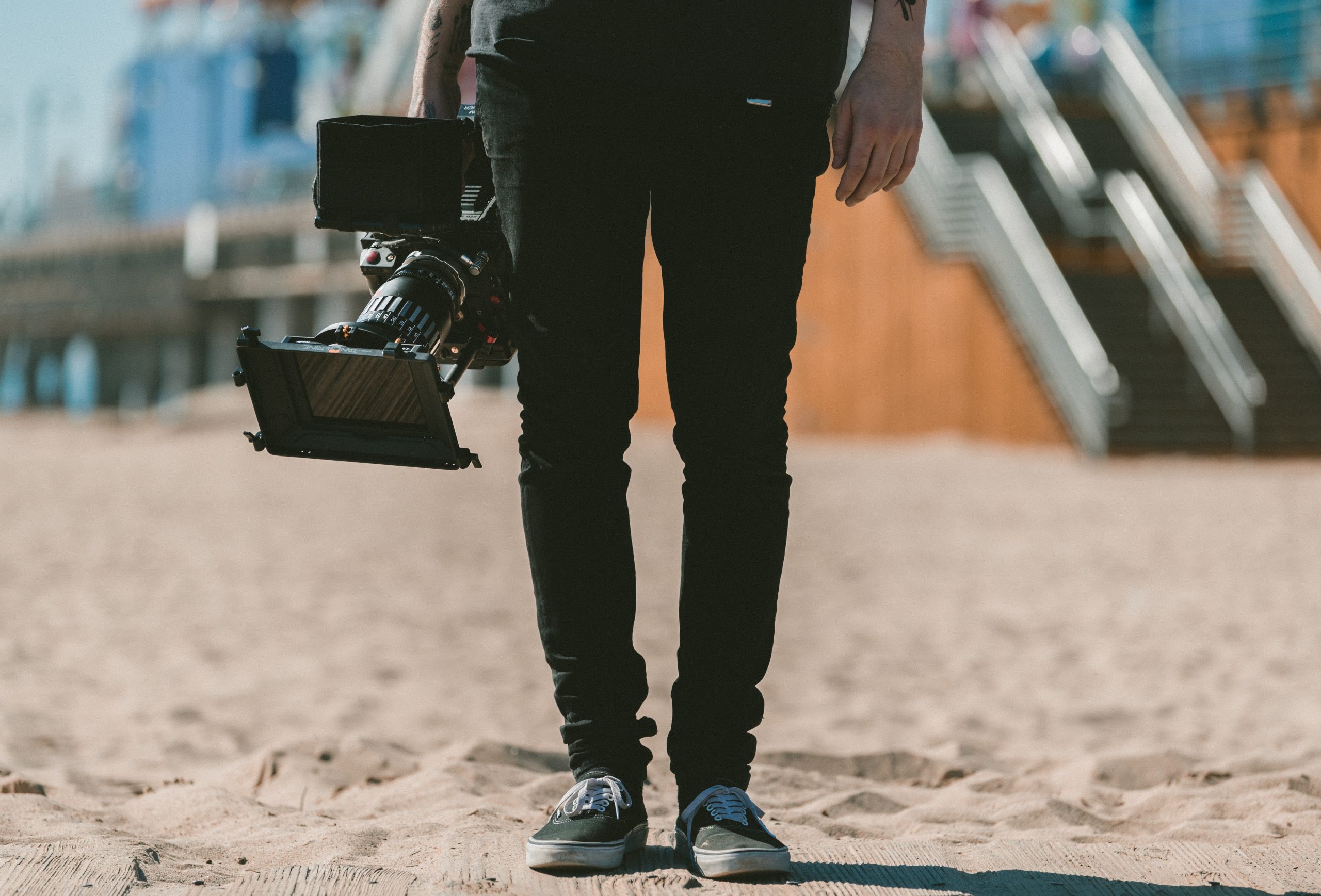 Cameraman holding a big camera, ready to shoot awesome digital video shorts.